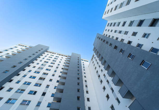 istock Low angle view of apartment building against clear blue sky 1937578291