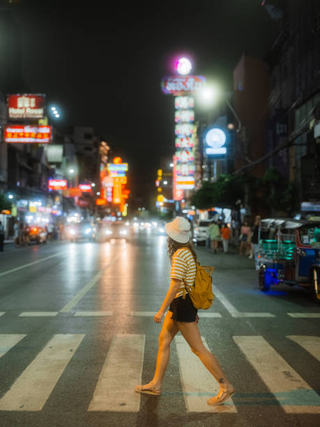 istock Woman on pedestrian crossing while exploring Bangkok Chinatown 1937578848