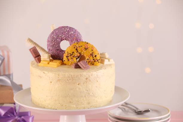 istock Delicious cake decorated with sweets against blurred lights, space for text 1937582614