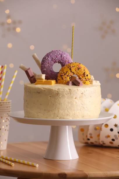 istock Delicious cake decorated with sweets and festive items on wooden table 1937583704