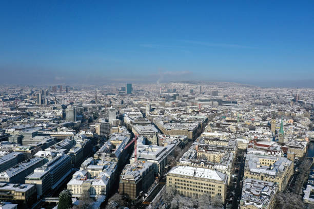 Zurich city snowcovered. The panoramic high angle image shows the city during winter season on a sunny day.