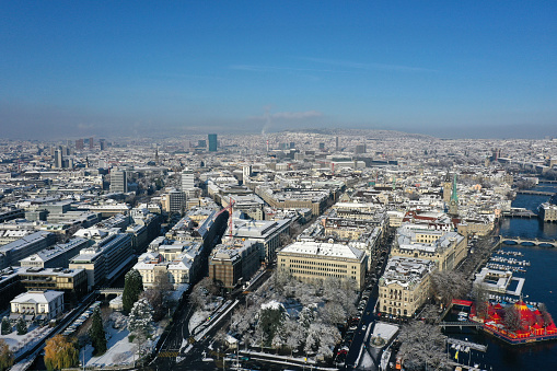 Zurich city snowcovered. The panoramic high angle image shows the city during winter season on a sunny day.