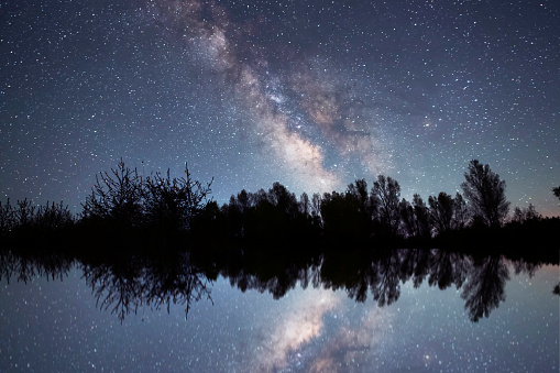 Beautiful night landscape,  bright Milky Way galaxy on the lake.