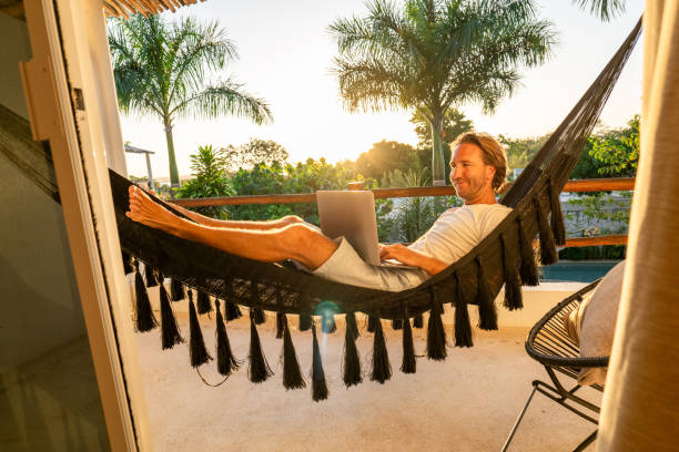 istock Entrepreneur working from hammock at sunrise 1937644116