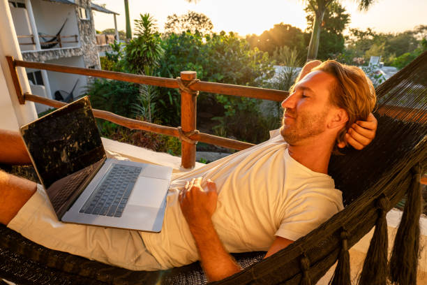 istock Entrepreneur working from hammock at sunrise 1937644620