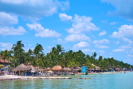 Beach in the Caribbean ocean with people and boats