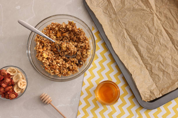 istock Making granola. Baking tray and ingredients on light grey marble table, flat lay 1937652107