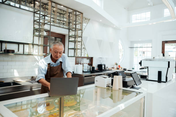 istock Global Connection: Senior Cafe Owner's Video Call for E-commerce Success 1937653702