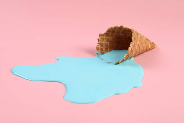istock Melted ice cream and wafer cone on pink background, closeup 1937669808