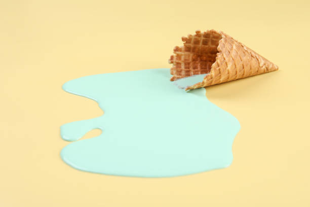 istock Melted ice cream and wafer cone on beige background 1937670674