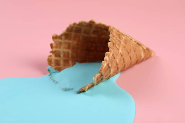 istock Melted ice cream and wafer cone on pink background, closeup 1937674477