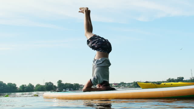 Young man integrates yoga exercises in weekend water training