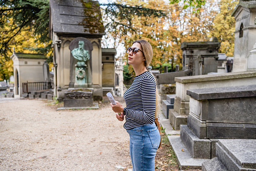 Woman at Pere Lachaise cemetery in Paris, France