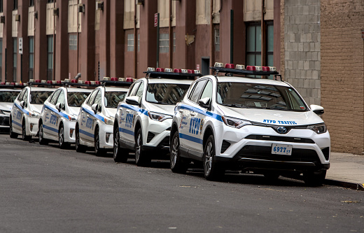Brooklyn, NY - Jan 15, 2023: NYPD traffic cruiser police cars parked on the side of a street in Brooklyn, New York City.