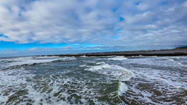 istock the water is rushing around the beach shore in the surf 1937708172