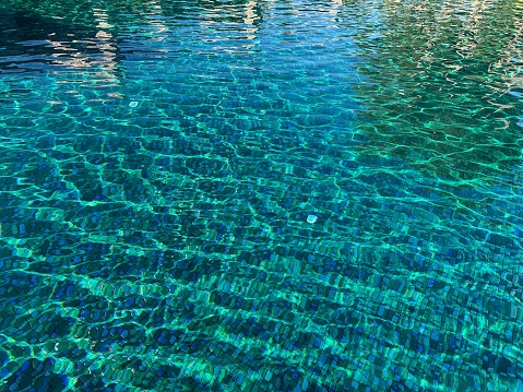 Clear water with ripples in outdoor swimming pool