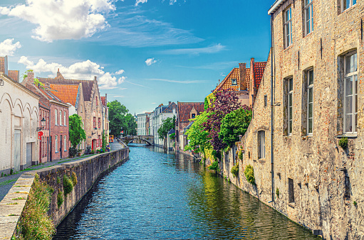 Bruges cityscape, Gouden-Handrei water canal of Reie river with Torenbrug Toren Bridge, medieval buildings on embankment in Brugge old town, Bruges city historical centre, Flemish Region, Belgium