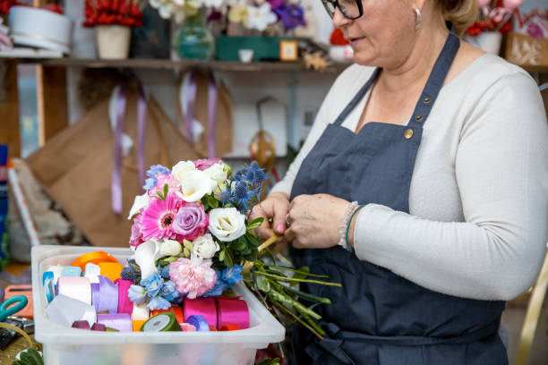 istock Woman working in flower shop 1937719974