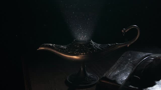 Aladdin's lamp with a book and a feather