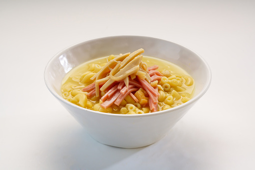 Imitation abalone and ham pasta served in bowl isolated on wooden table side view of hong kong fast food