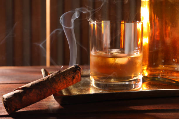 istock Tray with smoldering cigar and whiskey on wooden table, closeup 1937793875