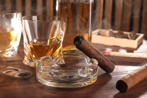 istock Cigars, ashtray, whiskey and cutter on wooden table, closeup 1937794407