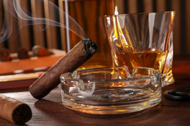 istock Cigars, ashtray, whiskey and cutter on wooden table, closeup 1937795976