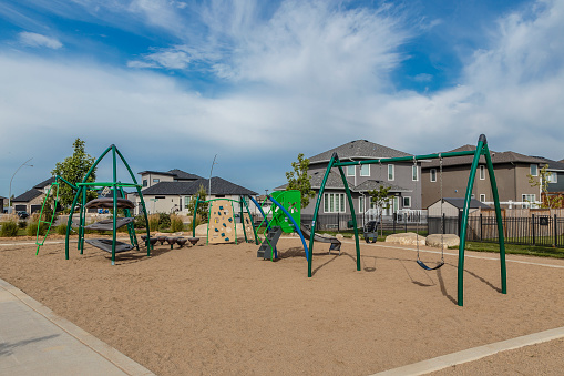 Outdoor playground with a slide and wooden swings