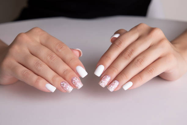 istock Female hands with pink and white manicure nails 1937823557