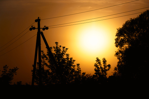 Sunset. Trees and power lines. Power lines during a beautiful sunset with trees.