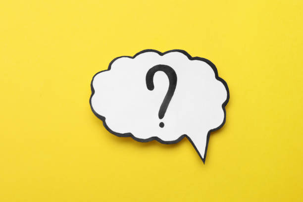 istock Paper speech bubble with question mark on yellow background, top view 1937827555