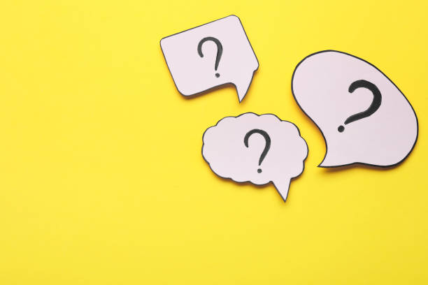 istock Paper speech bubbles with question marks on yellow background, flat lay. Space for text 1937829772