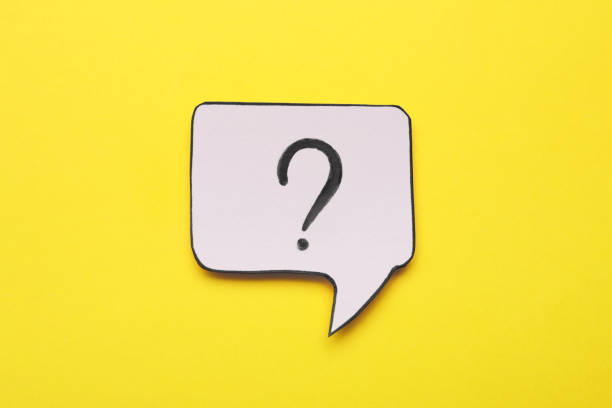 istock Paper speech bubble with question mark on yellow background, top view 1937829783