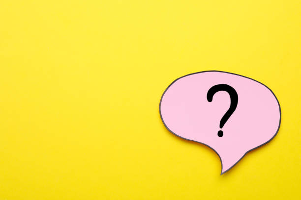 istock Paper speech bubble with question mark on yellow background, top view. Space for text 1937829785