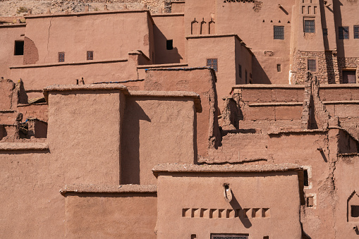 A moroccan clay village in a desert with a green oasis