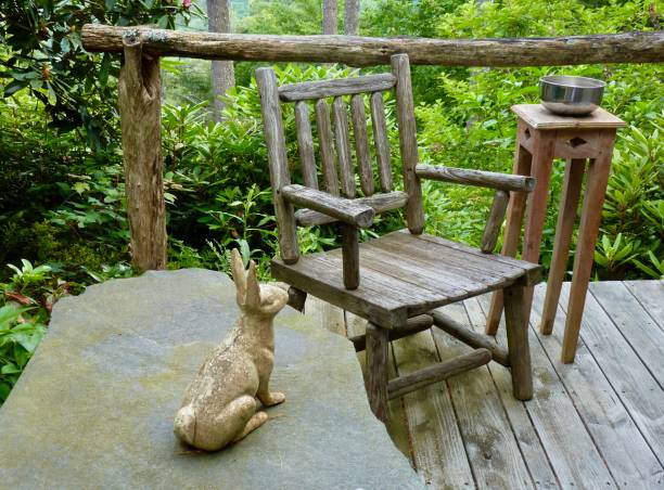 istock Rustic wooden chair and stone bunny on a mountain deck 1937847607