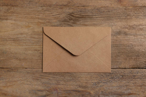 istock Paper envelope on wooden table, top view 1937850289