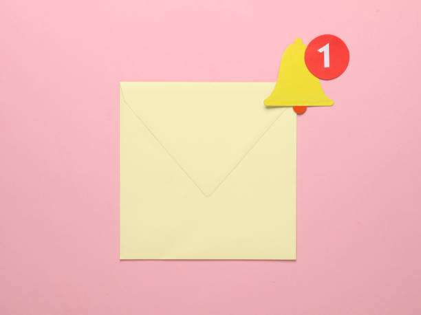 istock Envelope and Paper cut notification bell icon on pink background 1937856781