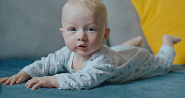 istock Cute Baby Boy Lying On Carpet At Home 1937879393