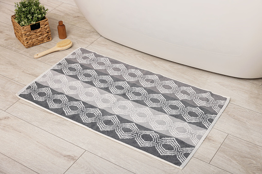 Soft bath mat with pattern on floor in bathroom