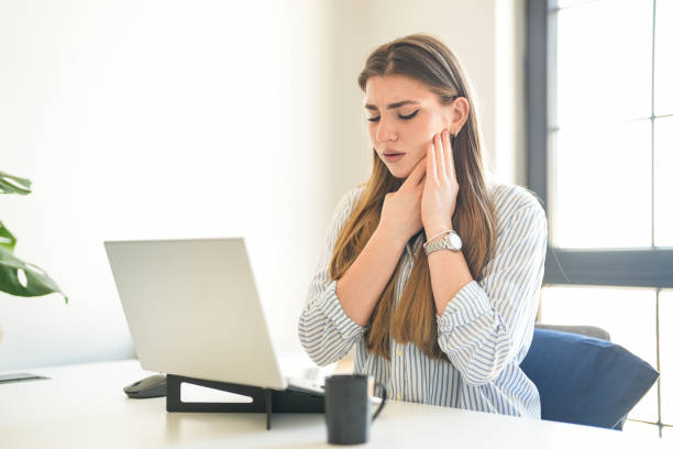 istock Young blonde woman drinking coffee working in the office has a toothache 1937892197
