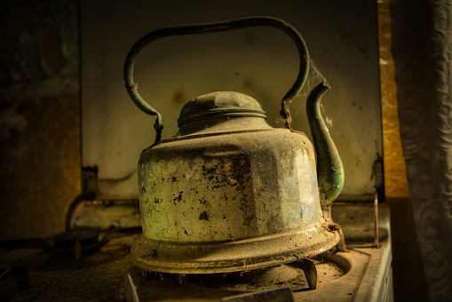 Old kettle on stove or oven for boiling water. Dusty and abandoned. Inspiration from a farmhouse that was demolished and lost in history.