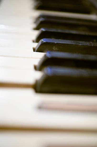 istock Old piano keys background, selective focus. Musical keyboard string instrument close-up. 1937923218
