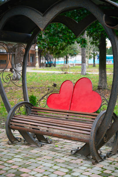 Bench with decorative support in the shape of two hearts. A vacation place for lovers.