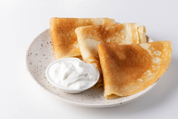 istock Stack of russian thin pancakes blini with fresh sour cream 1937953358