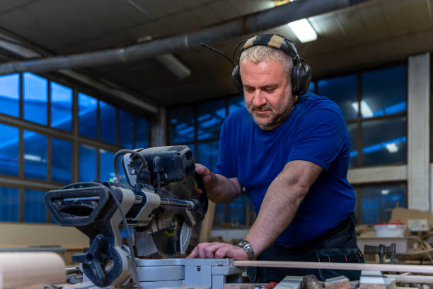 istock A middle-aged carpenter works on a table circular saw in the carpentry workshop. 1937967562