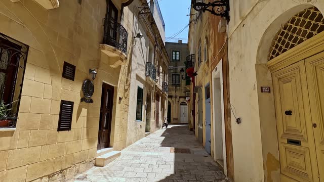 Walking Through Narrow Alley In Victoria On Gozo