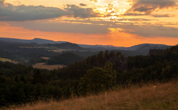 istock Mountain landscape with meadows and forests at sunset. 1937993322