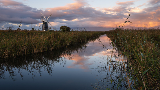 Colourful cloudy sky over Mutton's mill and reedbeds at Halvergate marshes in the Norfolk Broads i Mutton's Mill, November 2023