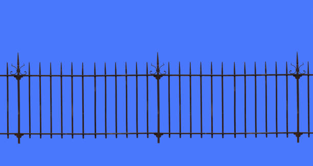 A wrought iron fence isolated on the blue background